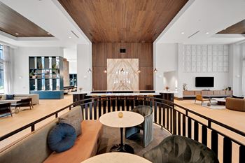 The lobby of a hotel with chairs and tables